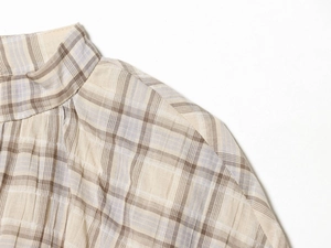 Detail of checkered beige crop top featuring textured seersucker fabric and neckline