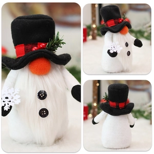 Close-up of Christmas gnome plush with black top hat, red berries, and white snowflake detail