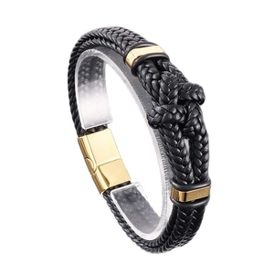 Men's braided black leather bracelet with golden magnetic clasp on display stand