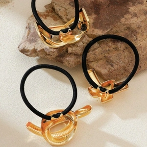 Three-piece gold geometric metal hair ties set with black high-elastic bands on stone