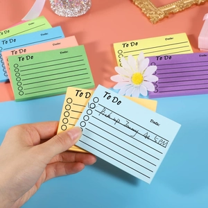 Close-up of colorful To Do List sticky notes with handwritten schedule on blue paper
