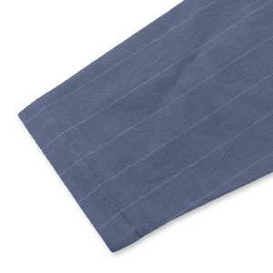 Detailed close-up of blue striped linen shirt cuff with premium woven texture and neat stitching