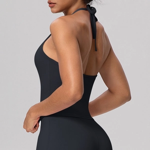 Detail of black halter yoga bra featuring high-elasticity fabric and open back tie design