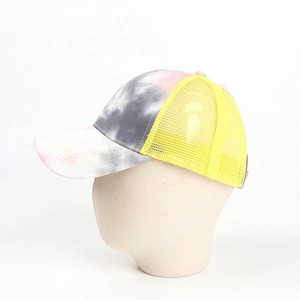 Detail of tie-dye ponytail baseball cap with breathable yellow mesh back on model