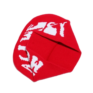 Detail of red and white jacquard knit beanie featuring Y2K style letter patterns