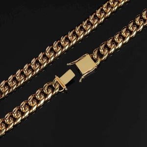 Detailed macro view of a 12mm gold Cuban link chain with a reinforced square safety clasp