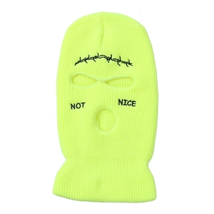 Detail of neon yellow knit balaclava with NOT NICE text and barbed wire embroidery