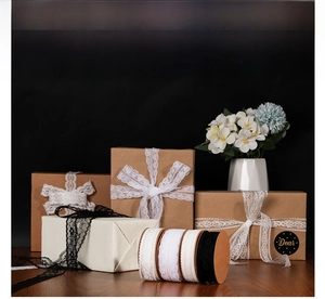 Detail of elegant black and white lace ribbons used for wedding gift box decoration
