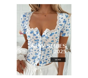 Detail of floral lace short sleeve top showing white knit texture and blue rose pattern