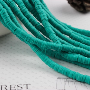 Detail shot of 4mm teal polymer clay heishi beads for DIY jewelry making and crafting