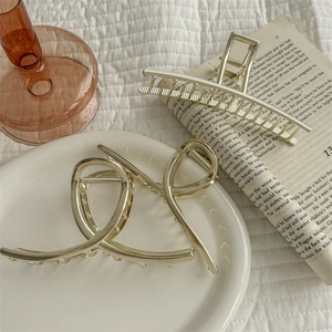 Polished silver metal hair claw clips set in geometric and twisted designs for women