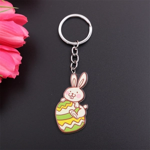 Easter keychain featuring a cute enamel rabbit holding a colorful egg on black background