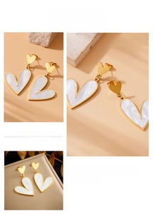 Detailed view of gold stainless steel heart earrings with white marble shell inlay