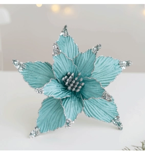 Macro detail of teal faux silk poinsettia with silver glitter edges and metallic center