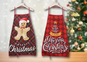 Detail of red plaid Christmas aprons with gingerbread man and festive typography