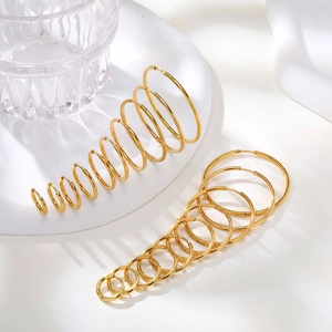Polished gold stainless steel hoop earrings set in various sizes on a clean white background