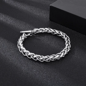 Detail of silver stainless steel wheat chain necklace with classic OT buckle on black fabric