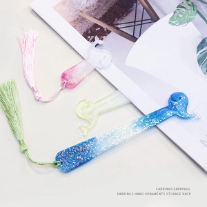 DIY glitter resin bookmark molds featuring whale tail shapes with matching tassels