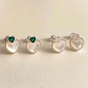 Detail of 925 sterling silver heart earrings with green zircon and iridescent mother of pearl