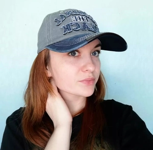Detail shot of vintage washed cotton baseball cap with embroidered THE BLACK lettering