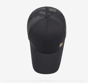 Top view of black mesh baseball cap showing breathable fabric and gold metal badge
