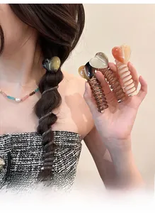 Detail of elastic spiral hair ties with marble pattern heart pendants and leopard print