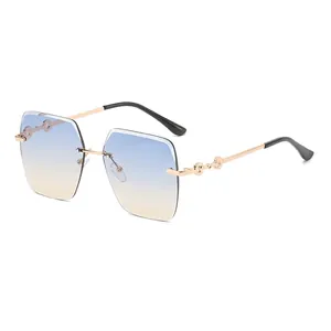 Frameless oversized square sunglasses with blue yellow gradient lenses and gold chain arms
