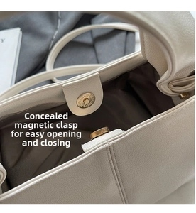 Detail view of the secure hidden magnetic closure and textured lychee leather bag