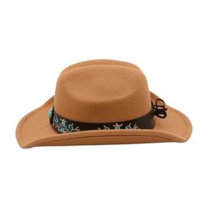Close-up detail of ethnic floral embroidery and turquoise bead on brown cowboy hat