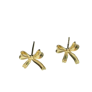 Elegant gold bow earrings with a polished metallic finish on a clean white background