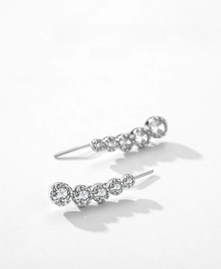 Macro detail of curved S925 sterling silver earrings with five gradient cubic zirconia stones