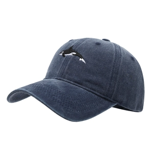 Navy blue washed cotton baseball cap featuring a detailed orca whale embroidery