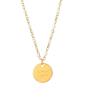 Detail of gold solar pendant necklace featuring white bead accents on a refined chain