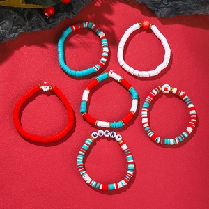 Detail of six-piece Christmas polymer clay bead bracelets with Merry charms and snowman pendants
