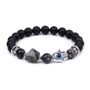 Detailed shot of beaded bracelet with Fatima hand charm and pyramid metal bead accents