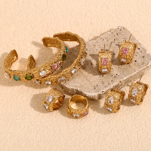 Detailed close-up of 18K gold plated irregular hammered jewelry set with colorful zircons