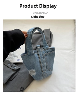 Detail of light blue denim bucket bag with vintage distressed edges and single handle