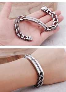 Detailed view of titanium steel Cuban bracelet with cross rhinestones and vintage carving