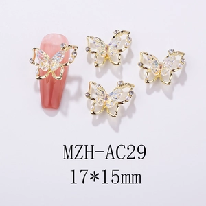 Detailed view of 17x15mm iridescent butterfly nail charms with pearls and gold frame
