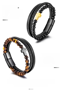 Detail of men's leather bracelet featuring tiger eye beads and stainless steel cross
