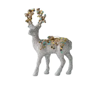 Sparkly silver Christmas reindeer figurine with colorful sequins on white background