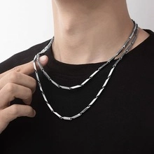 Detail view of titanium steel snake chain featuring polished rectangular links for men