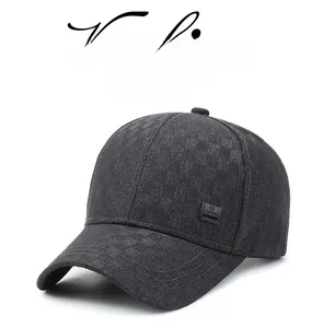 Close-up of black textured baseball cap with rectangular fashion label and curved brim