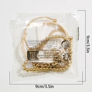Detail showing gold beaded and snake chain bracelet set in clear packaging 9cm size