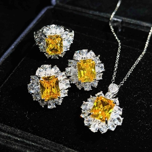 Luxurious four-piece silver jewelry set with yellow gemstones in black velvet box