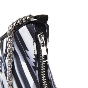Detail of bohemian handbag with black and white geometric fabric and silver chain