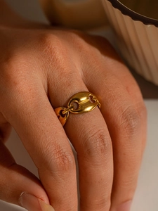 Detailed close-up of a golden pig nose chain ring showing refined polished texture and fit