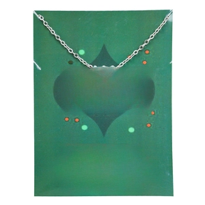 Detail of silver snowflake pendant necklace on a decorative holiday display card