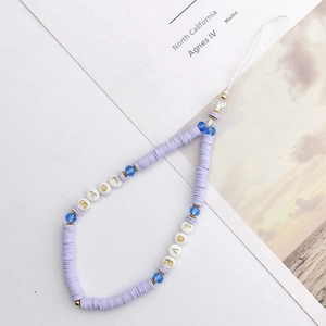 Detail of colorful LOVE beaded phone charm with purple clay heishi and blue crystal beads