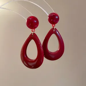 Retro resin teardrop earrings in wine red with hollow design and silver pin studs